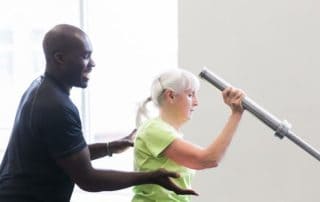 Personal Trainer Gbolahan working with a client on staying healthy and fit.