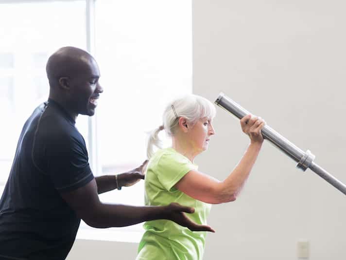 Personal Trainer Gbolahan working with a client on staying healthy and fit.