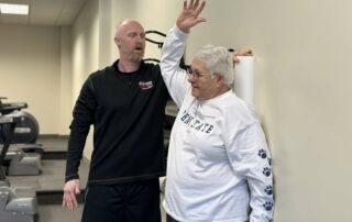 senior client on the foam roller during her personal training session