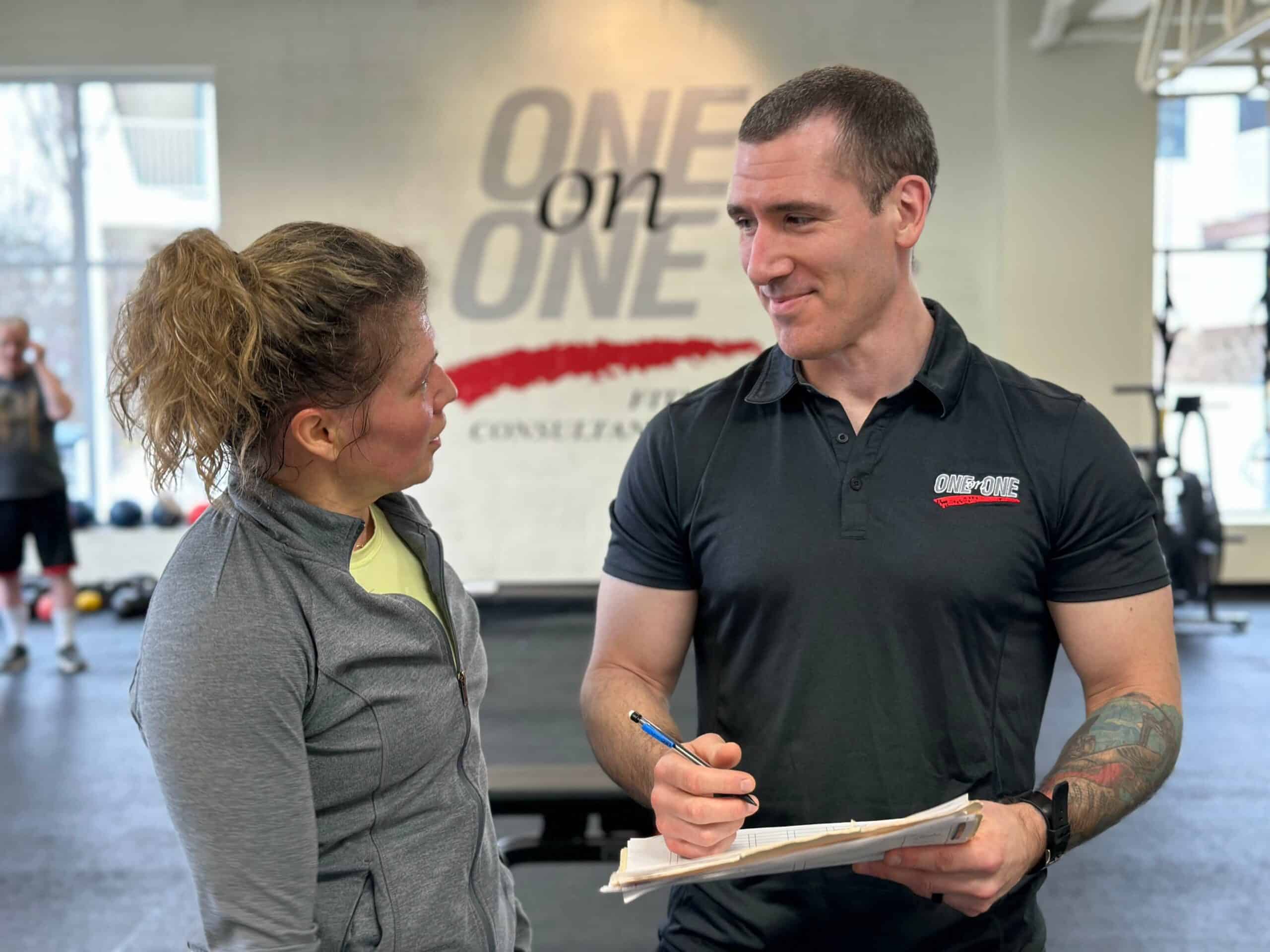 Personal trainer and registered dietitian Geoff Borro consulting with a client in the gym