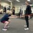Client performing an assisted squat during her personal training session