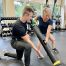 Client performing Vipr Shovel with trainer cuing