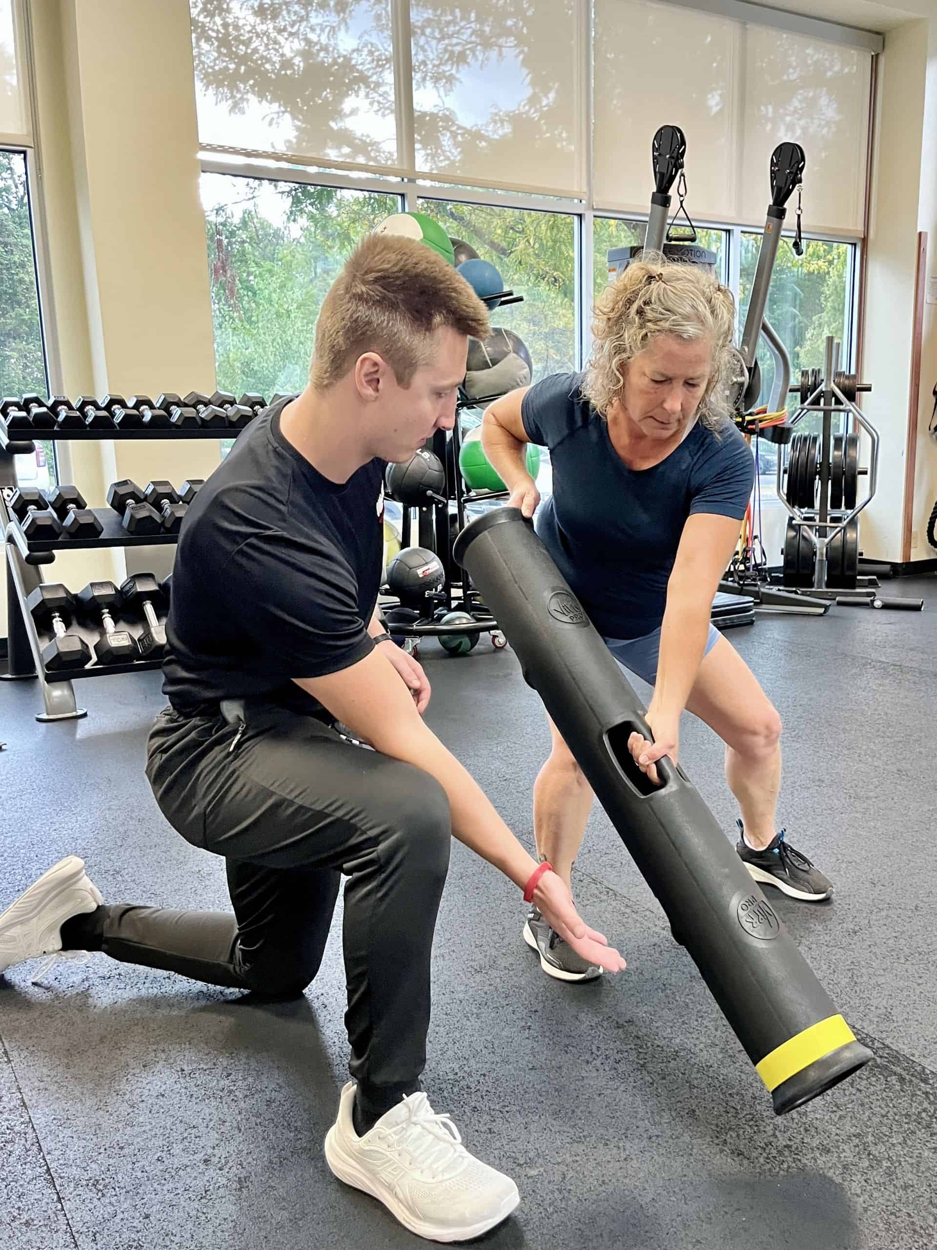 Client performing Vipr Shovel with trainer cuing