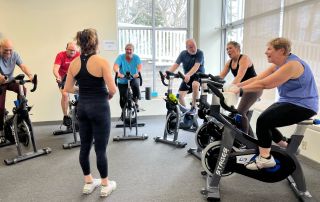 Personalized one-on-one fitness training session for seniors in a modern gym setting.