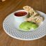 Breakfast burrito served with avocado and salsa