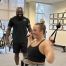 Trainer putting client through lat pulldown exercise