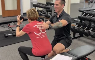 Personal training session at a gym with a focus on one-on-one fitness coaching.