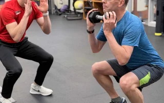 Dynamic one-on-one fitness training session at State College Fitness Consultants.