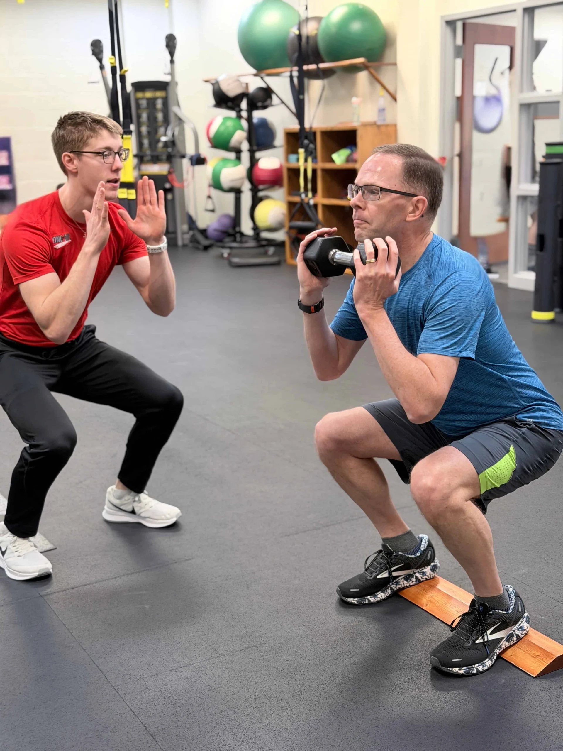 Dynamic one-on-one fitness training session at State College Fitness Consultants.